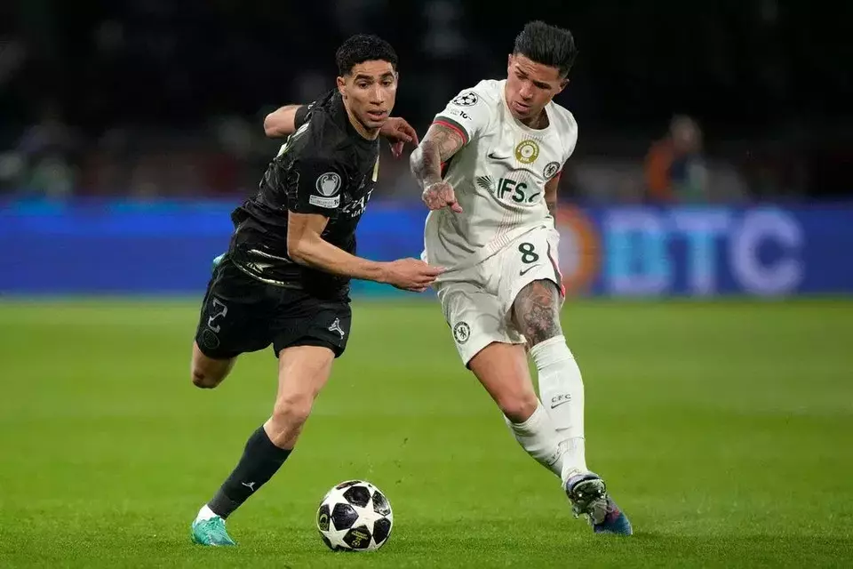 Pemain PSG Achraf Hakimi (kiri) berebut bola dengan Enzo Fernandez dari Chelsea pada leg pertama pertandingan sepak bola babak 16 besar Liga Champions di Paris, Rabu, 11 Maret 2026. (AP/Michel Euler)